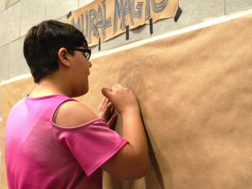 teenager-drawing-on-mural-wall-cropped